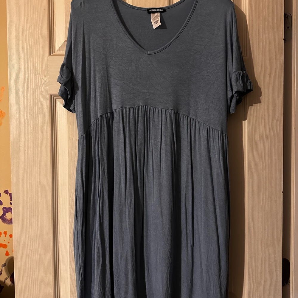 Denim blue baby doll style top.  Fairly long and is short ruffle sleeves.